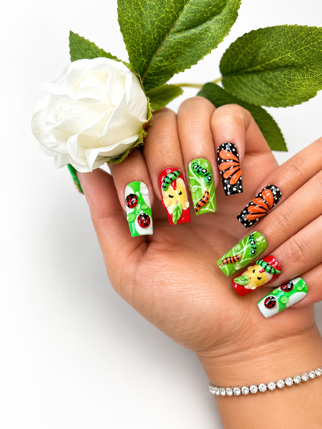 Detailed nature-themed nail art with a white rose, created at Miami Valley Nail Salon & Spa in Cincinnati, OH